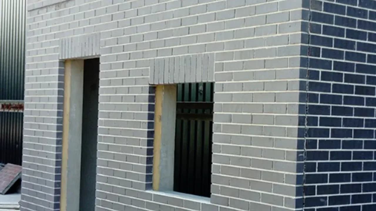 Brick faced panels with their openings formed in the factory, so the finish and the reveals arrive with the wall rather than being built onto it afterwards.